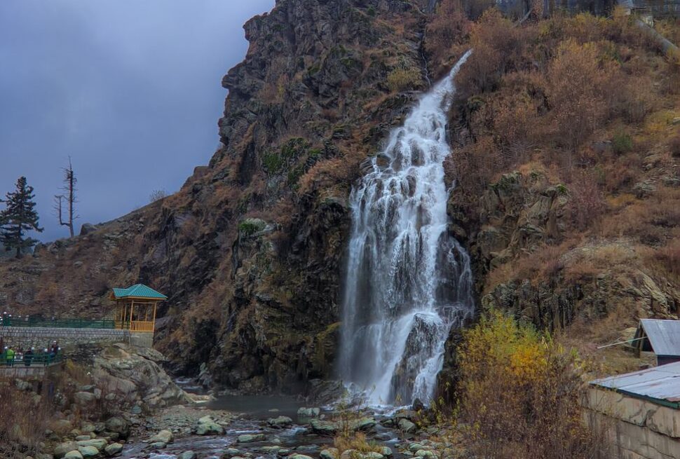 Spectacular waterfall in Drung surrounded by rugged natural landscape.