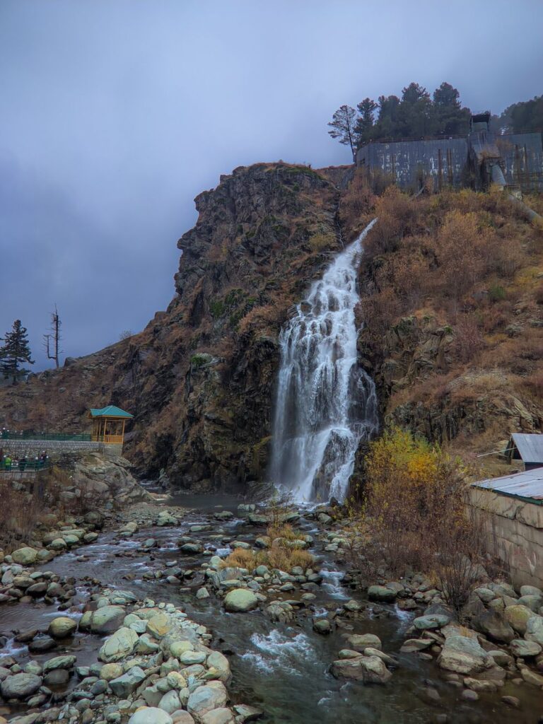 Spectacular waterfall in Drung surrounded by rugged natural landscape.